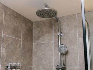 a grey shower inside the bathroom boxing